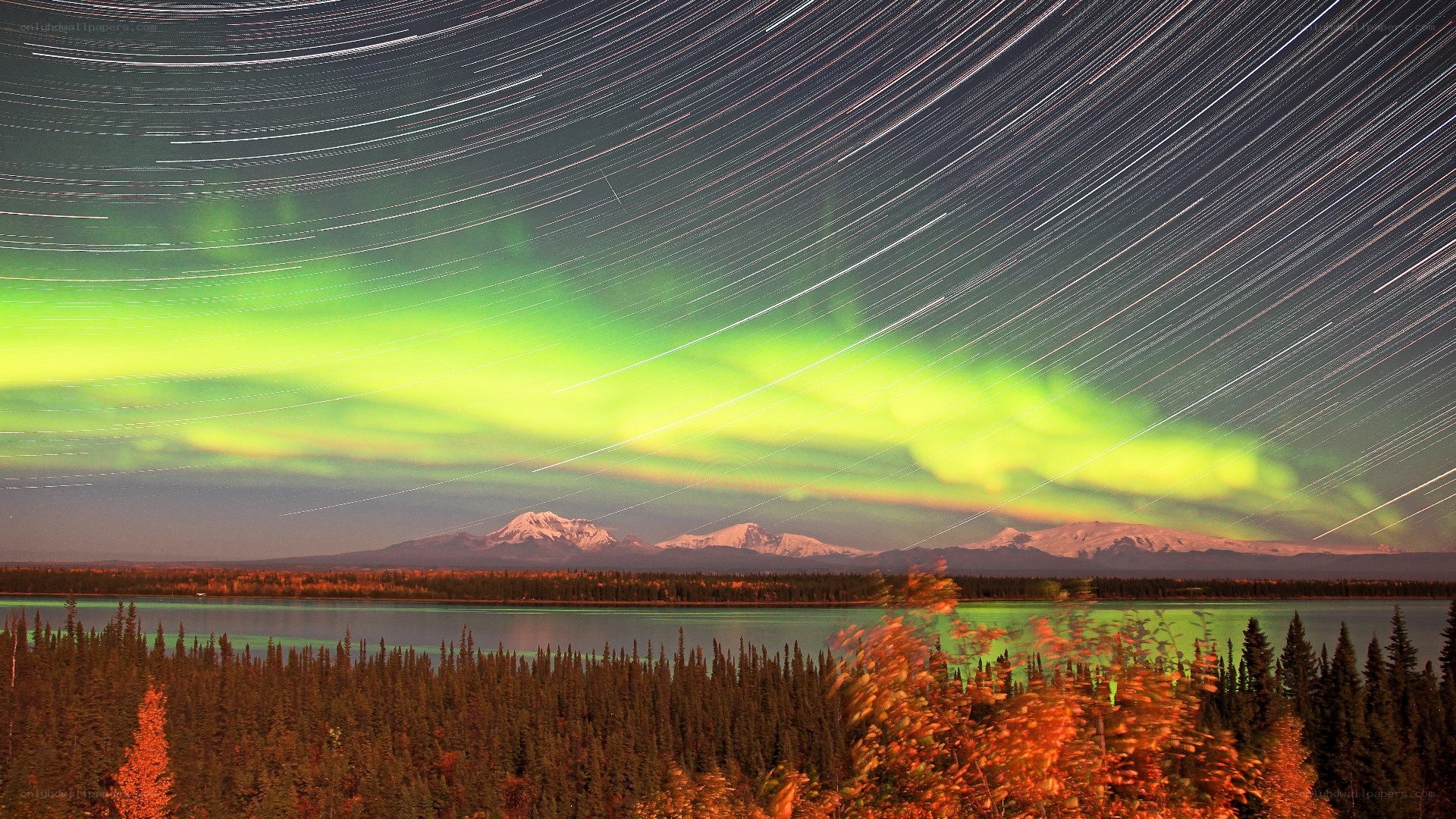 Aurora over a lake and mountains