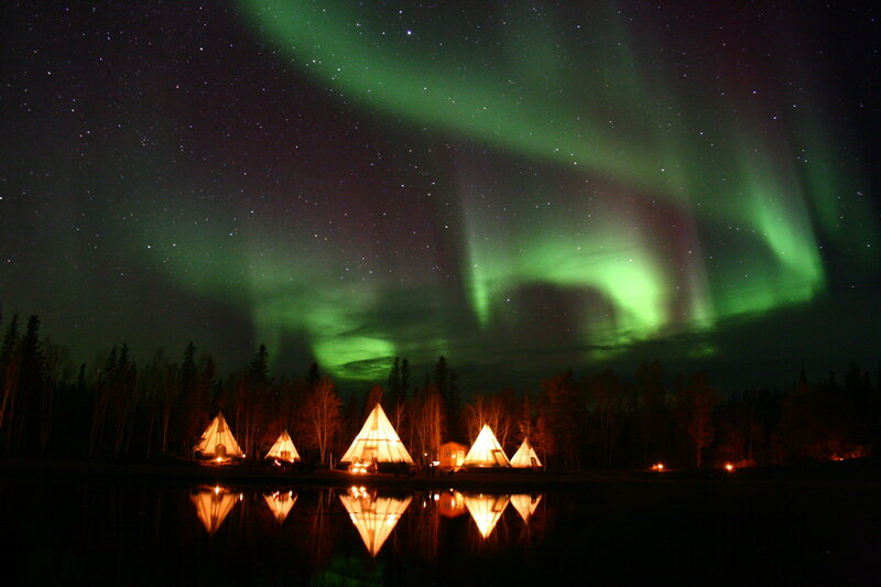 Aurora over a lakeside camp