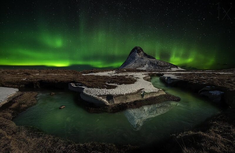 Aurora over a mountain lake