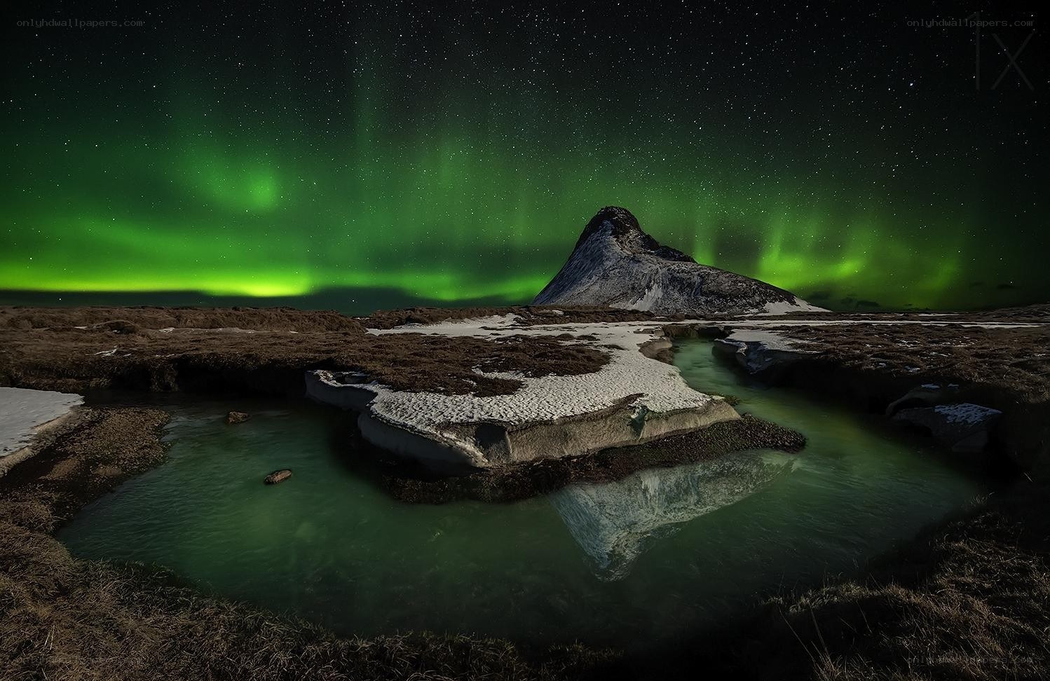 Aurora over a mountain lake