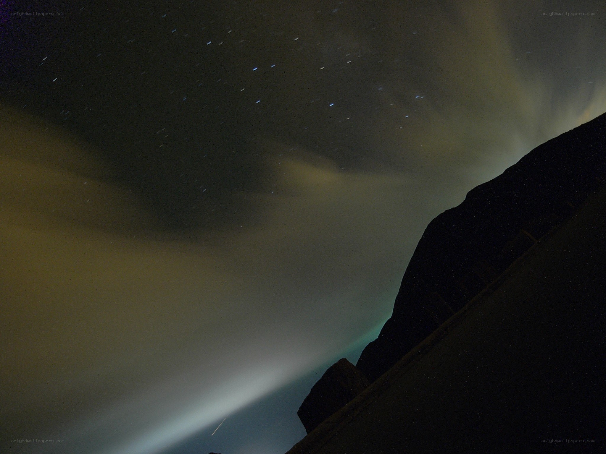 Aurora over a mountain silhouette