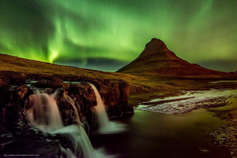 Aurora over a mountain waterfall