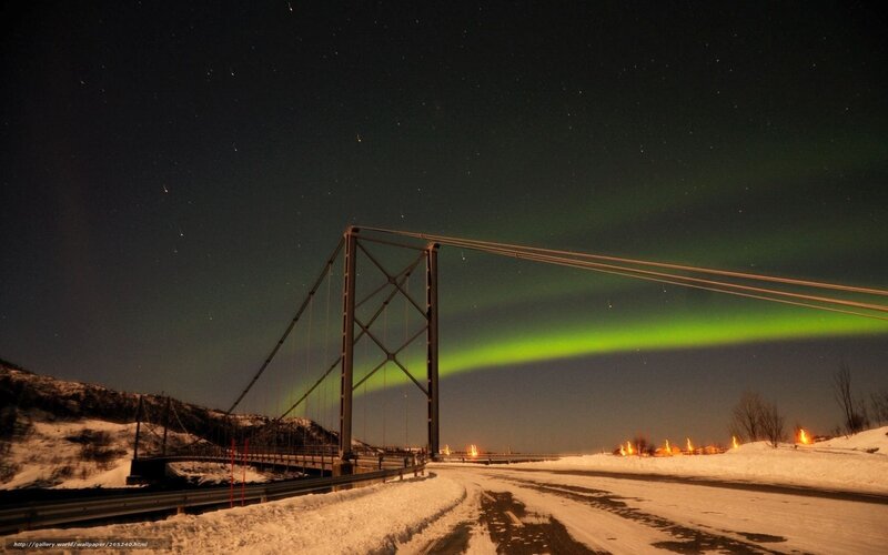 Aurora over a snowy bridge