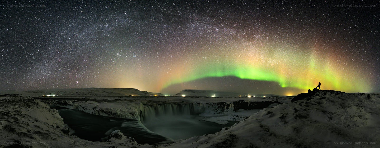 Aurora over a snowy waterfall
