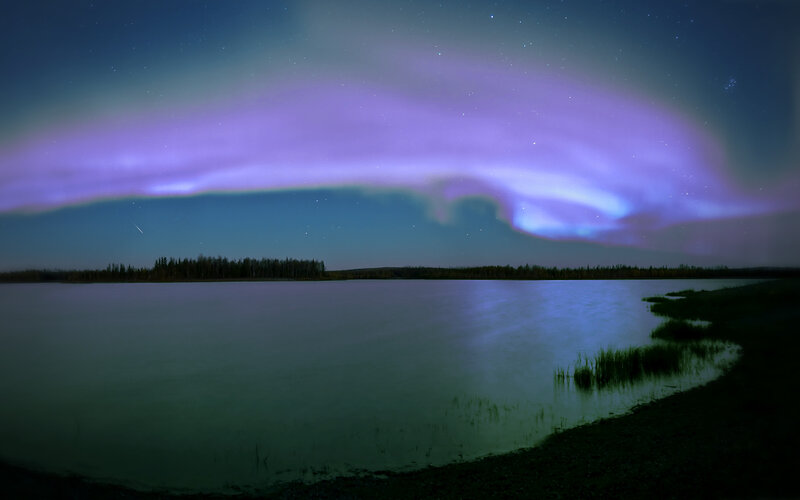 Aurora over a tranquil lake