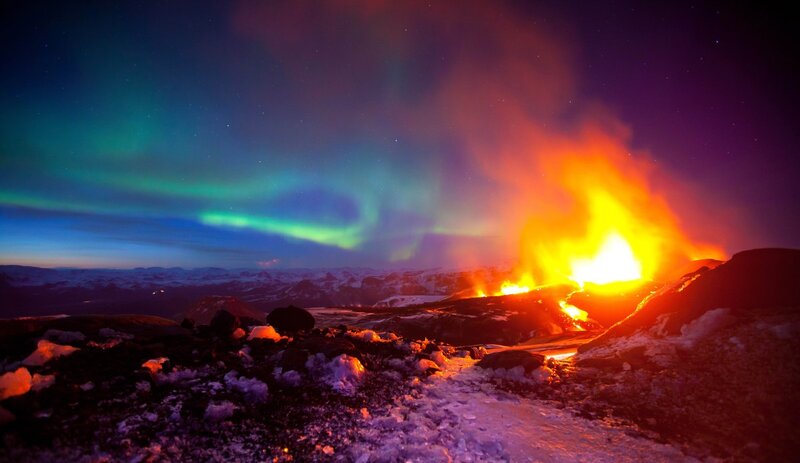 Aurora over a volcanic eruption