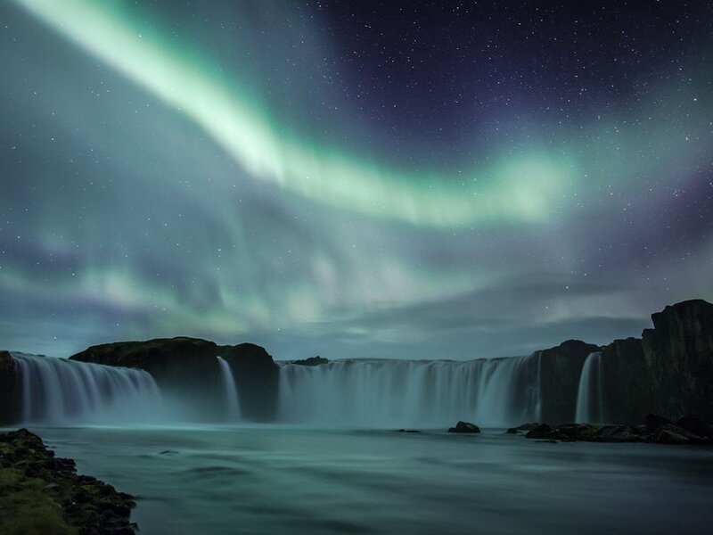 Aurora over a waterfall
