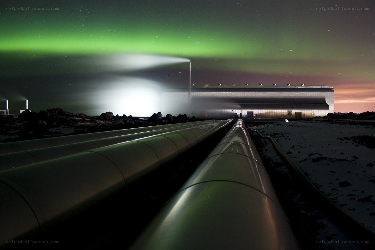 Aurora over industrial pipes