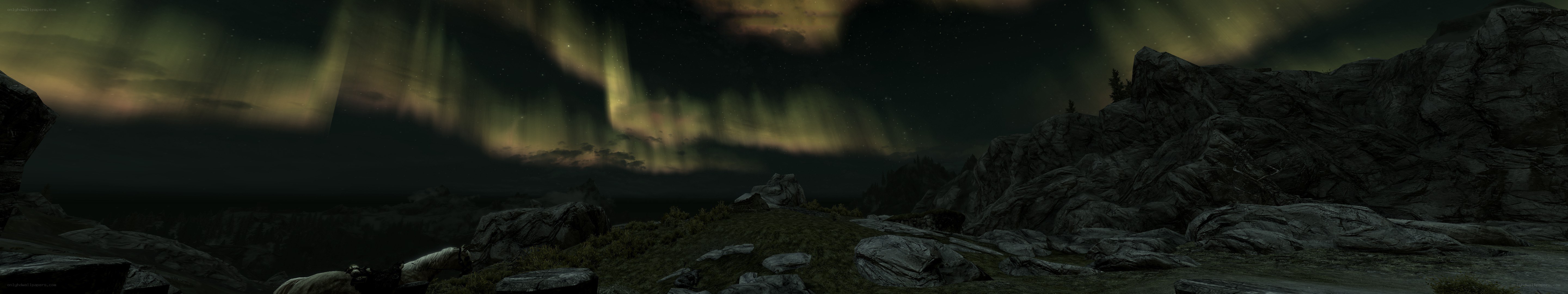 Aurora over rocky landscape