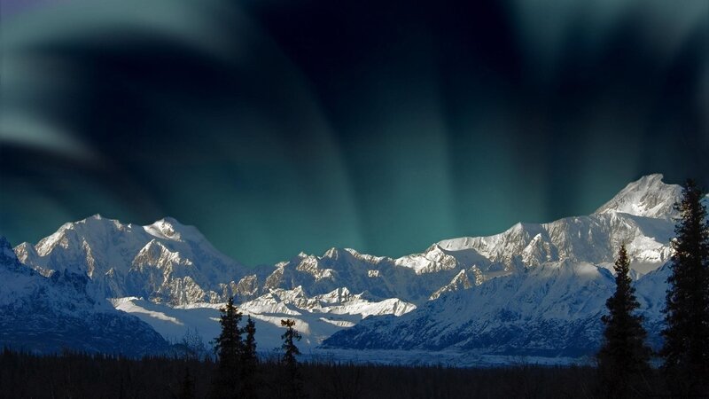Aurora over snow-capped mountains