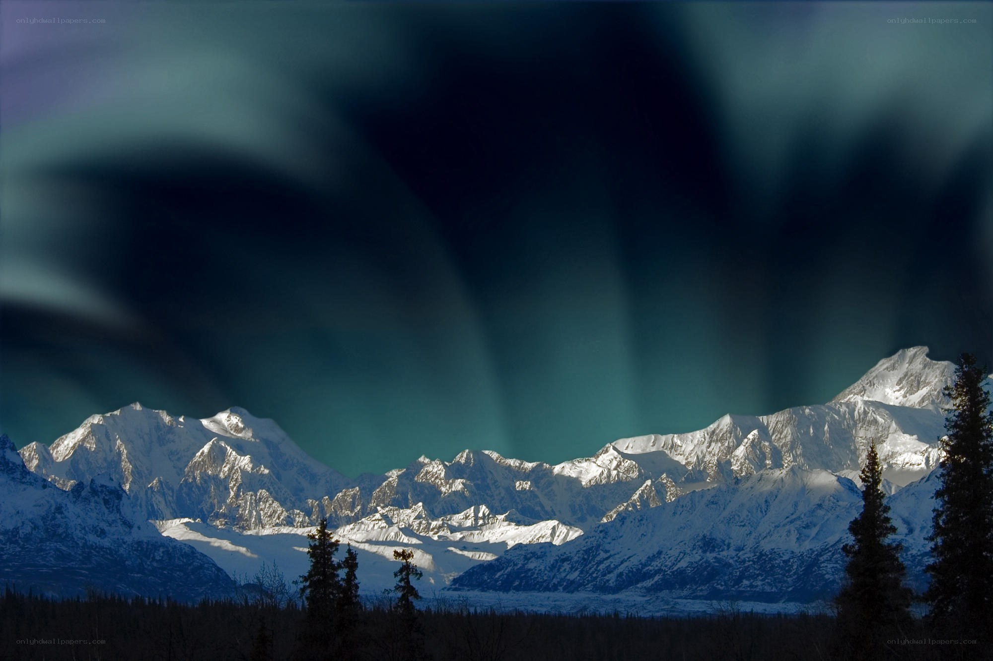 Aurora over snow-capped mountains