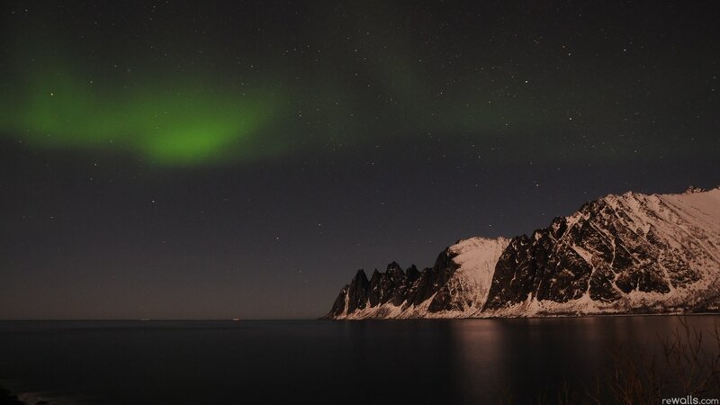 Aurora over snowy mountains