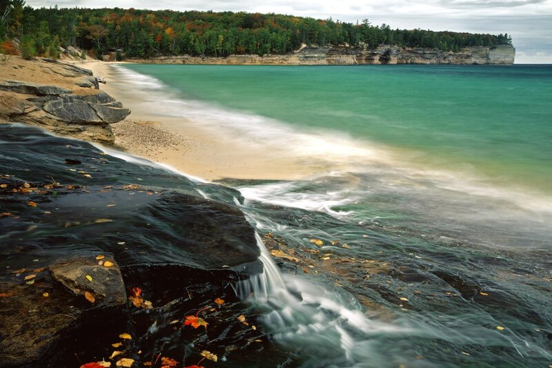 Autumn beach with waterfall