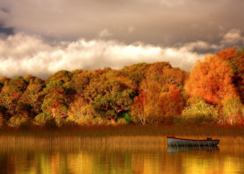Autumn boat on a calm lake