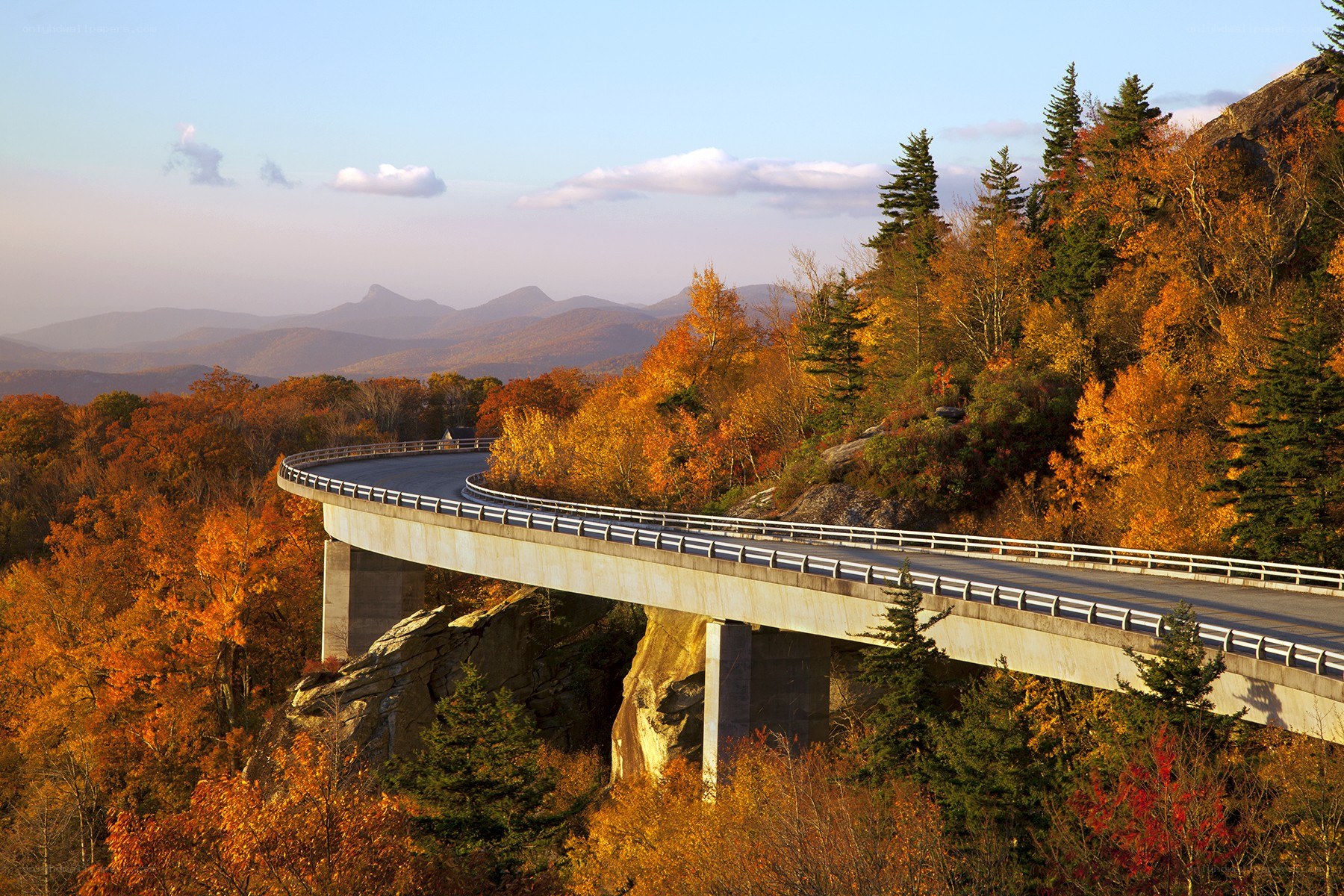 Autumn bridge over mountain valley