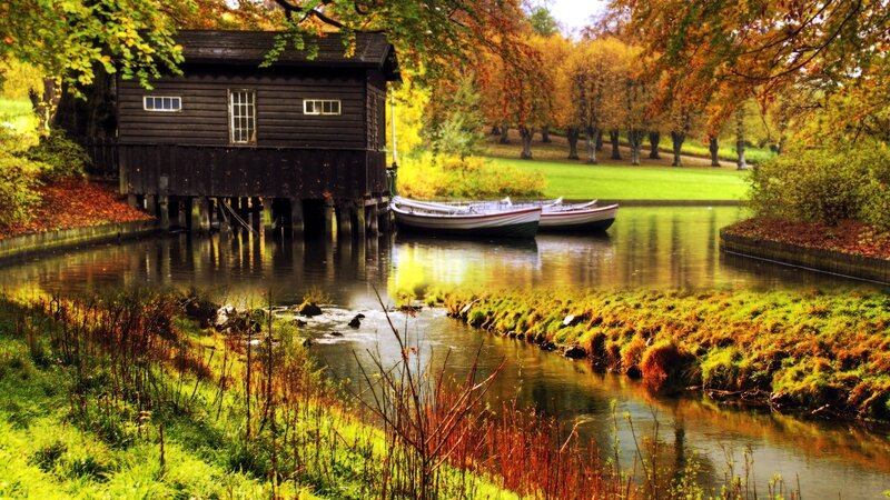 Autumn canal with boathouse