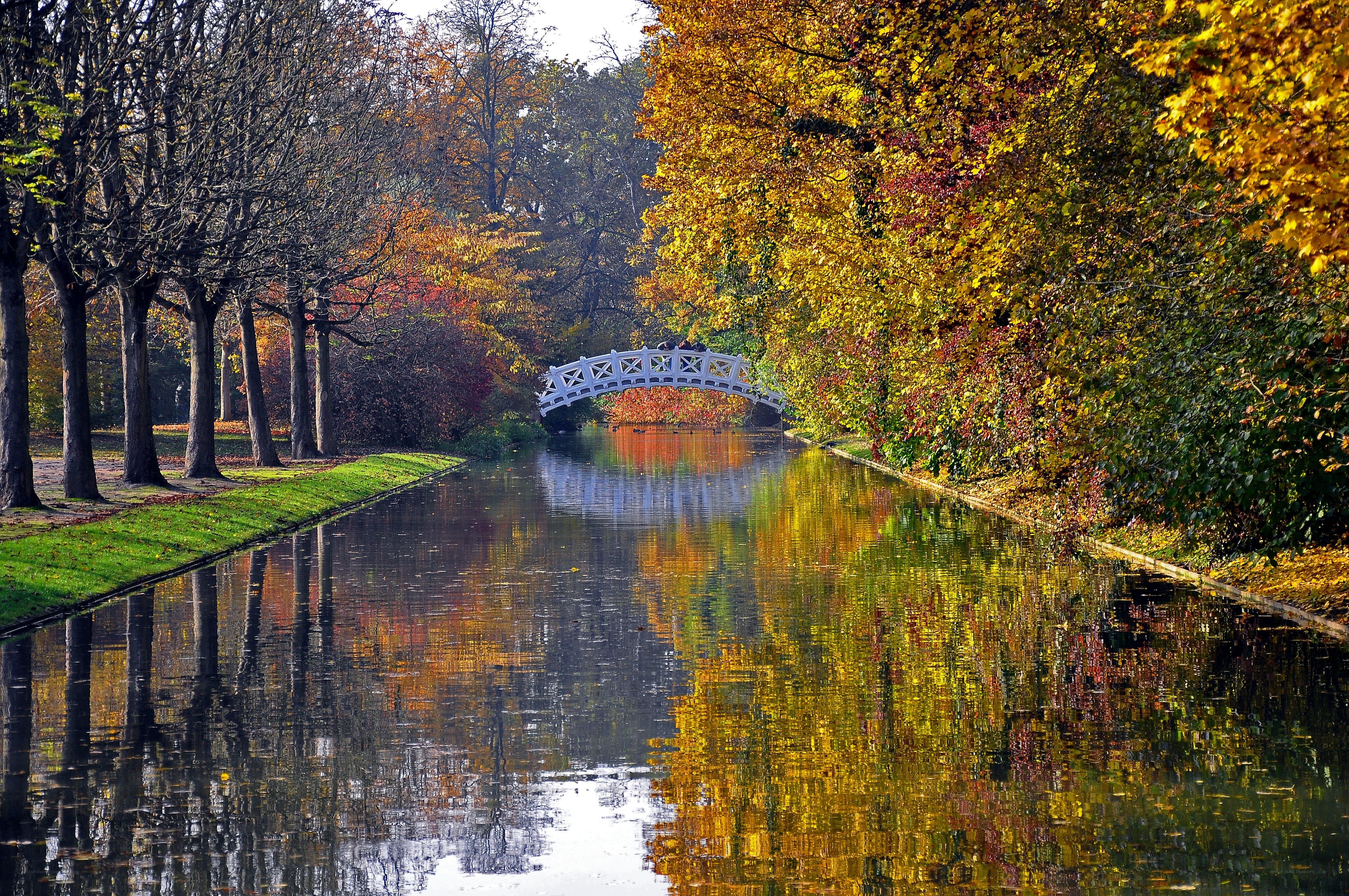Autumn canal with white bridge