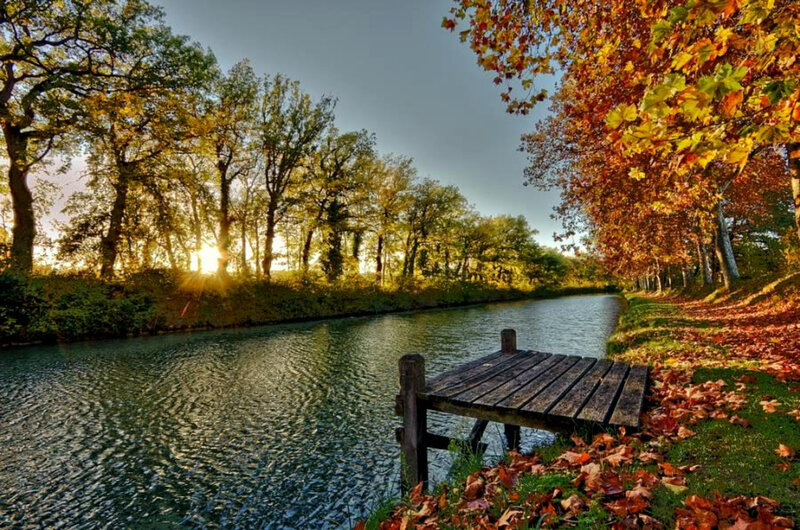 Autumn canal with wooden dock