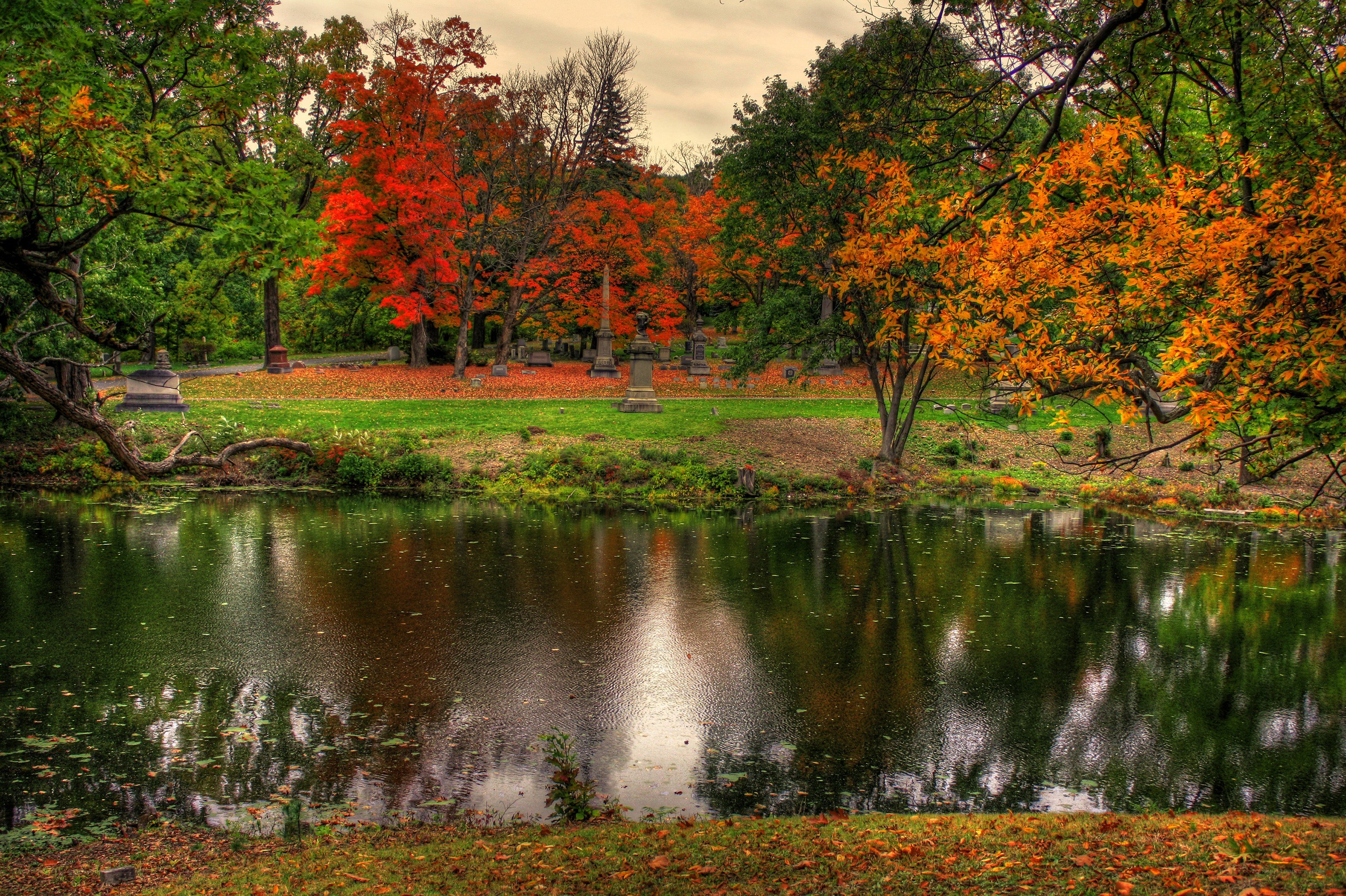 Autumn cemetery by a pond