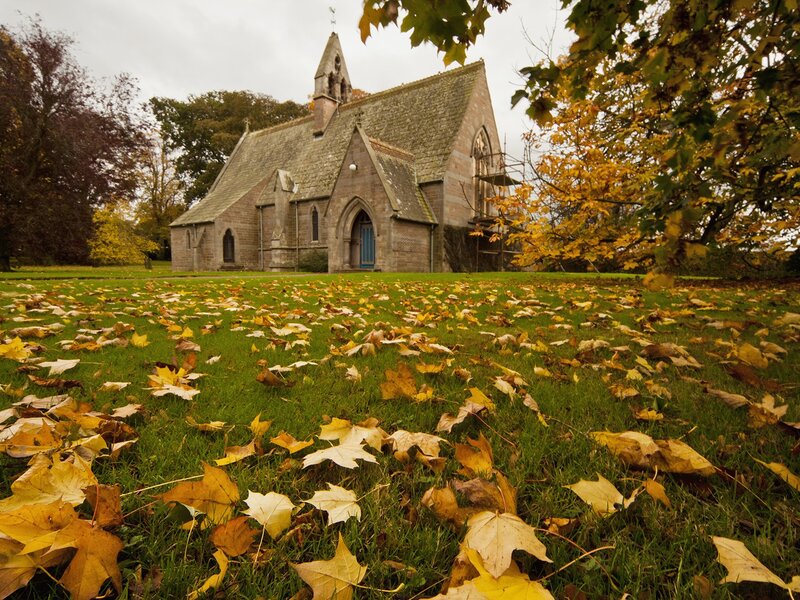 Autumn church with fallen leaves