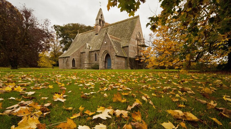 Autumn church with fallen leaves