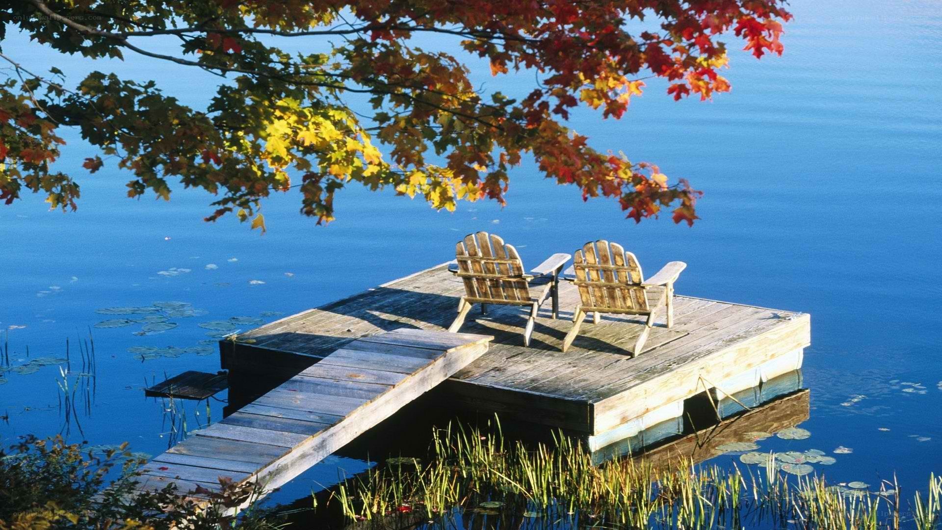 Autumn dock with Adirondack chairs