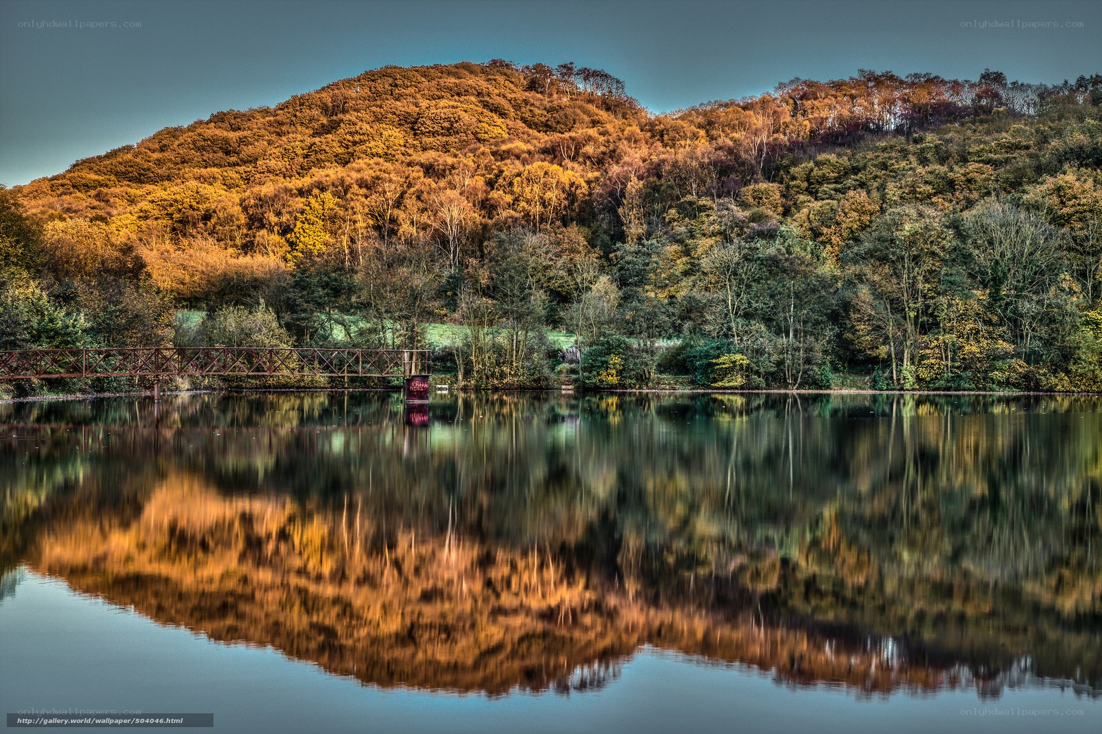 Autumn hill reflected in lake