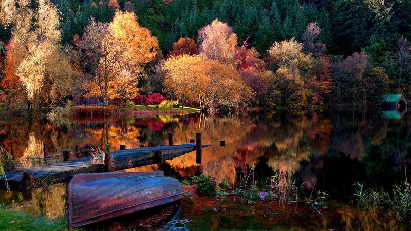 Autumn lake with boat and dock