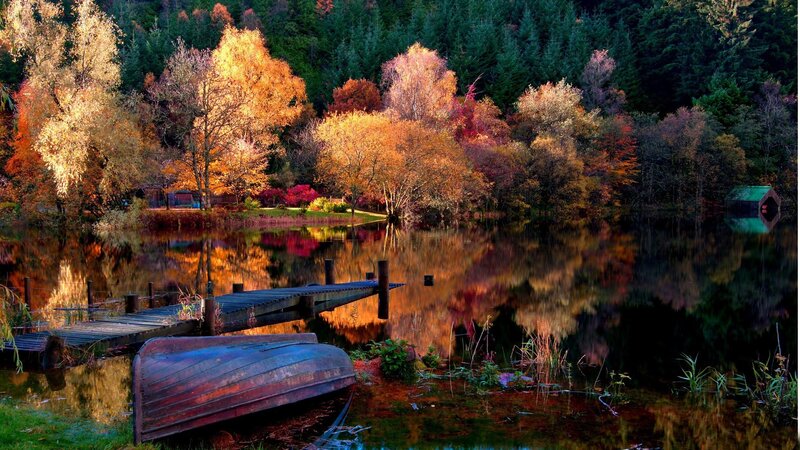 Autumn lake with boat and dock