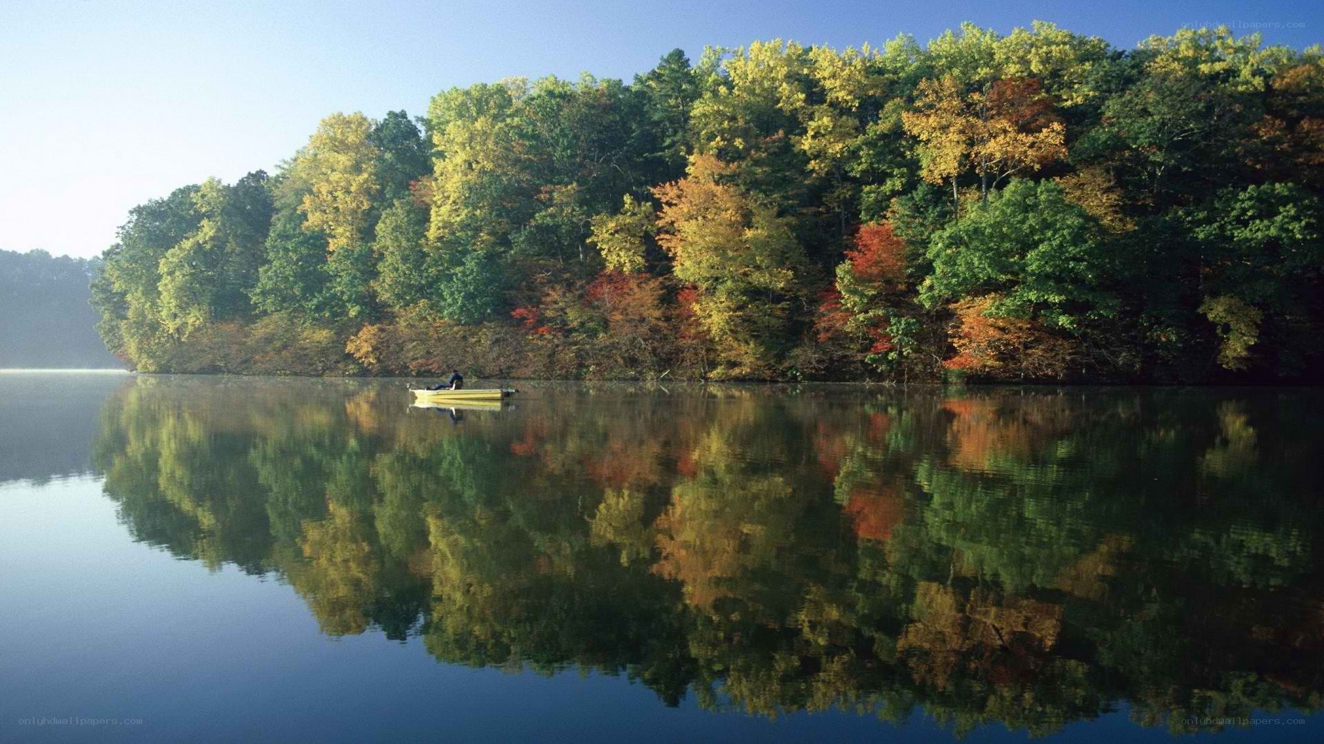 Autumn lake with boat reflection