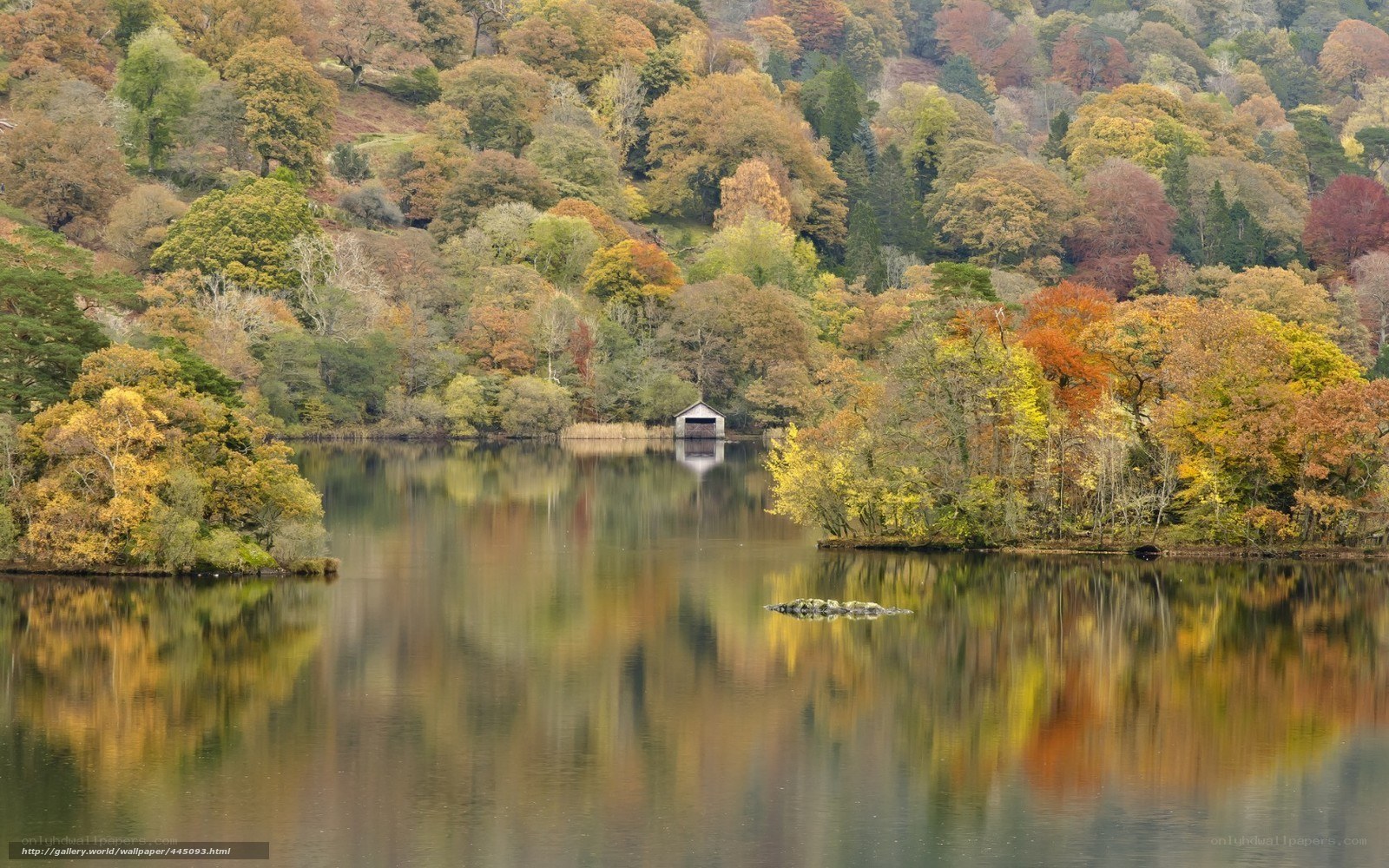 Autumn lake with boathouse