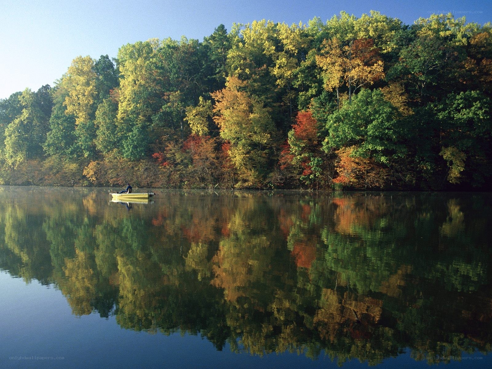 Autumn lake with canoe reflection