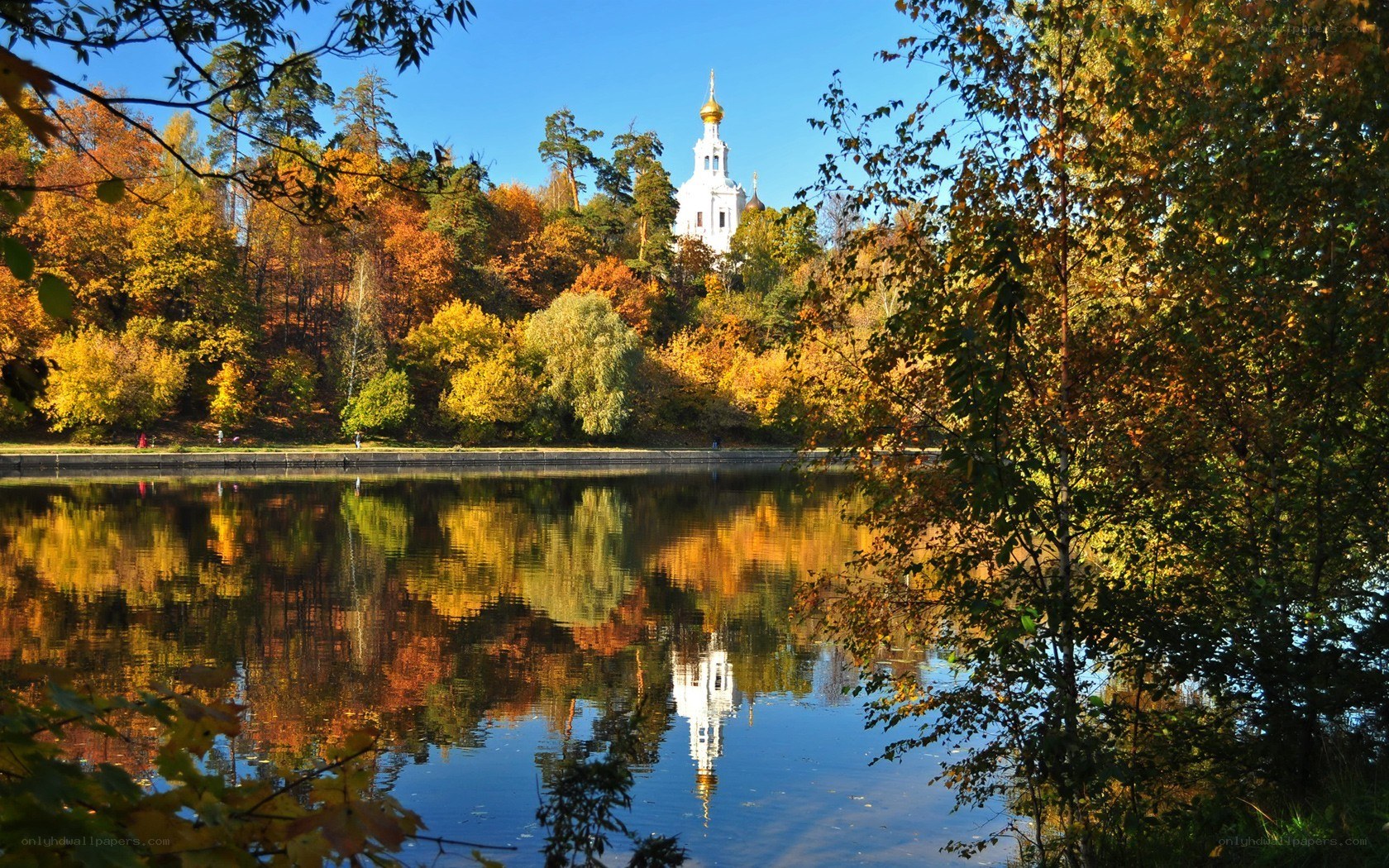 Autumn lake with church reflection
