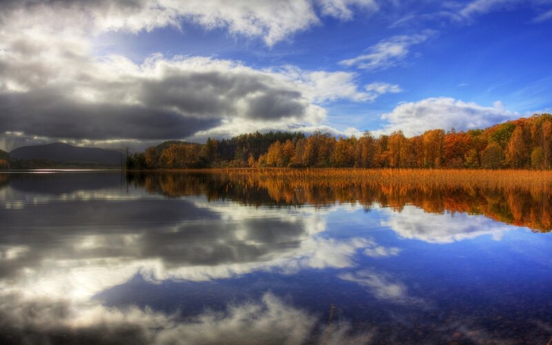 Autumn lake with cloudy sky
