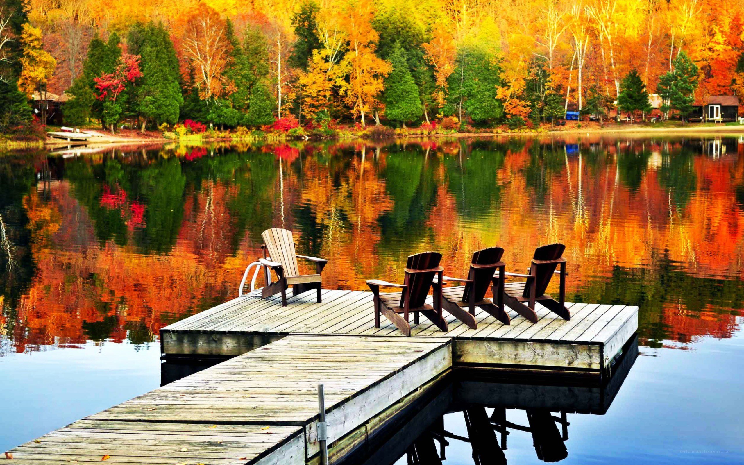Autumn lake with dock chairs