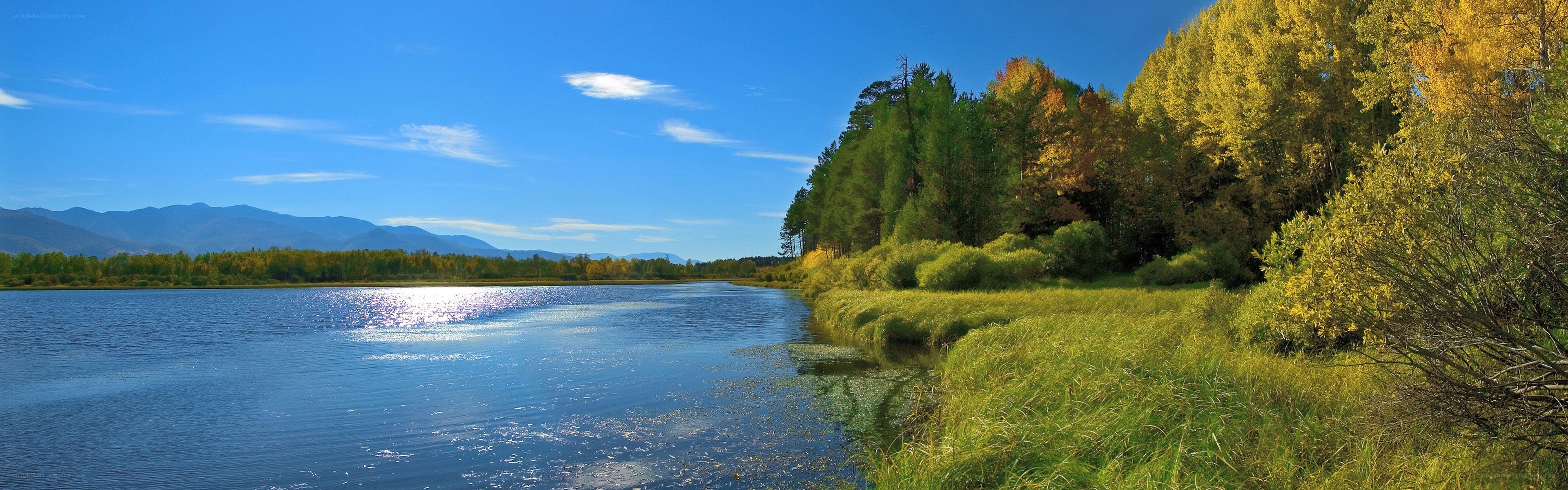 Autumn lake with forest and mountains