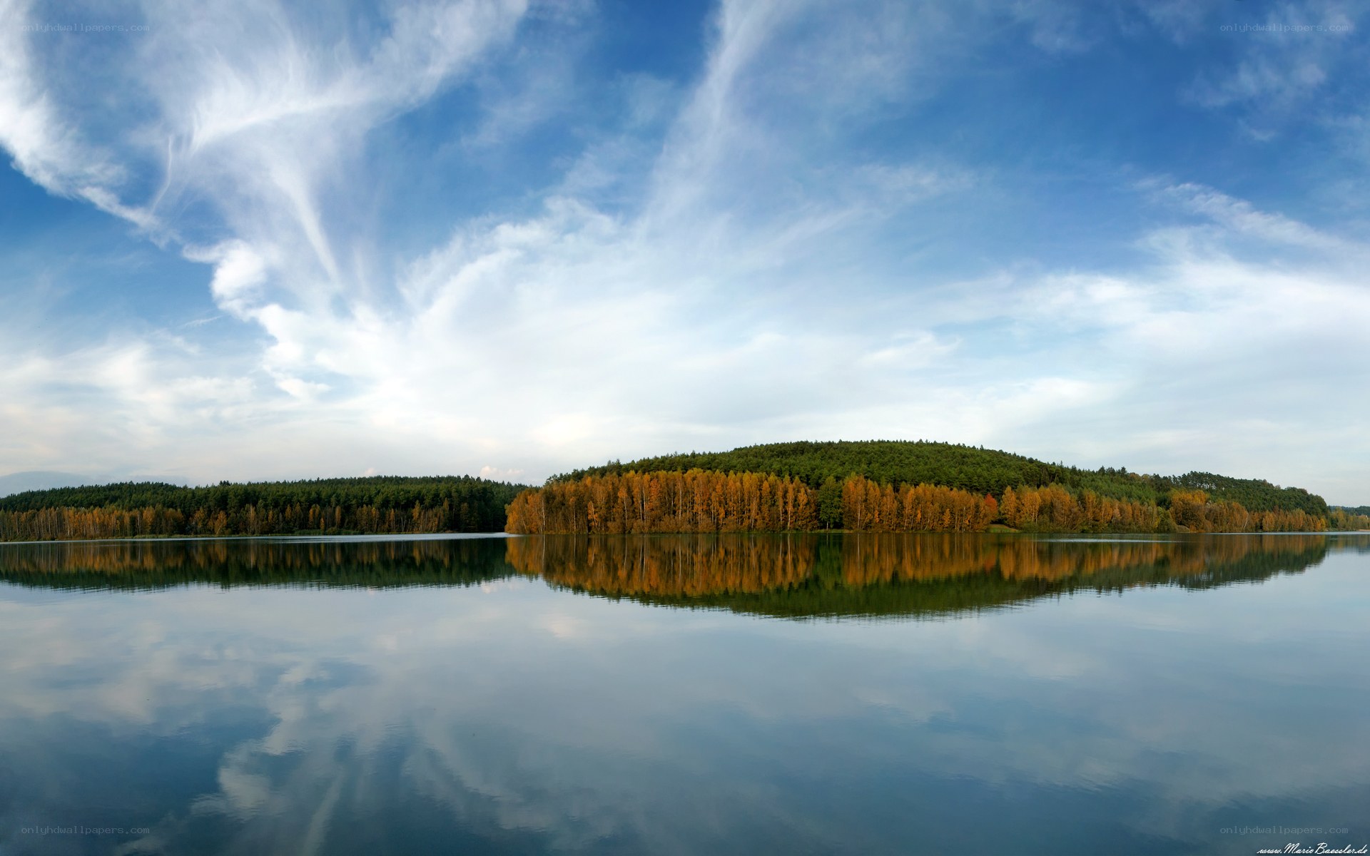 Autumn lake with forest reflection