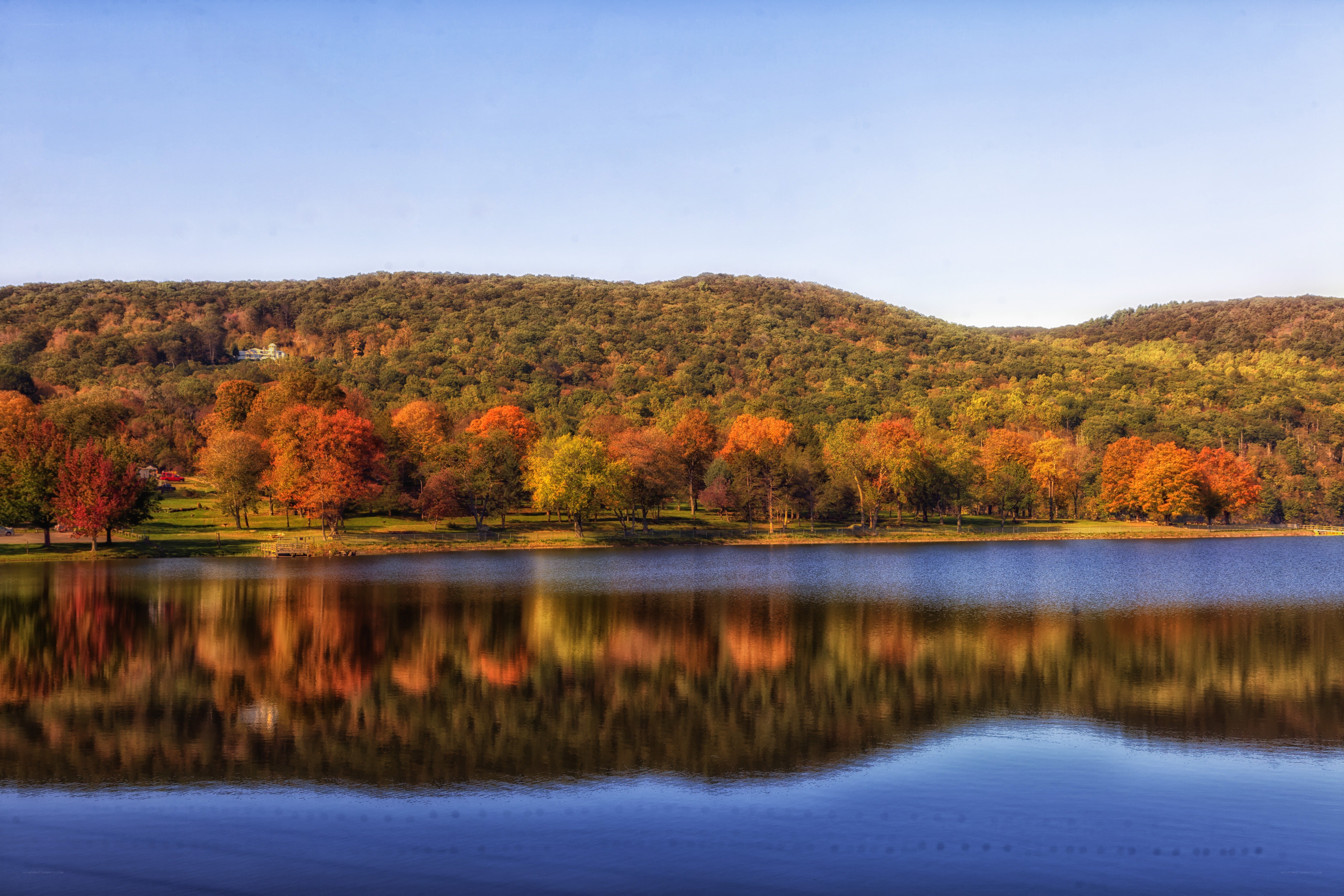 Autumn lake with forest reflection