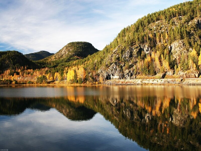 Autumn lake with forested hills