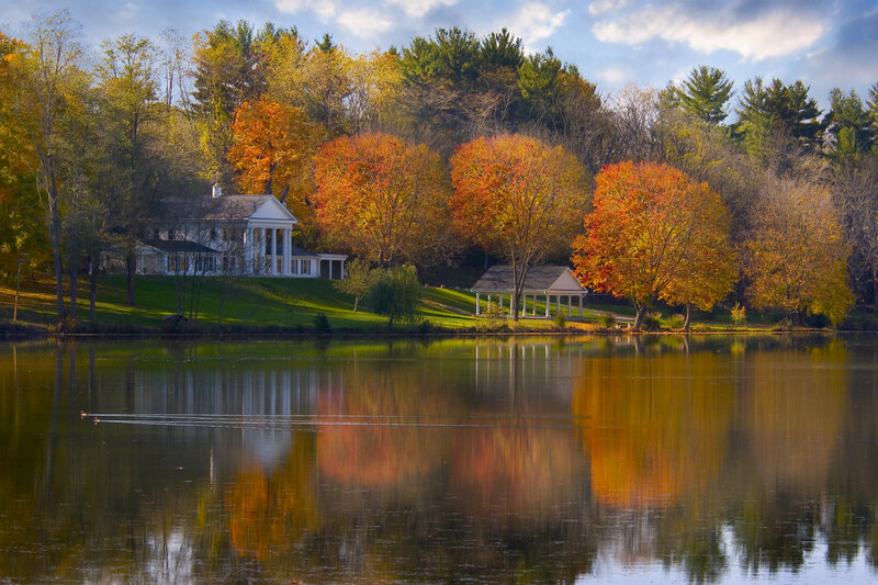 Autumn lake with house and gazebo