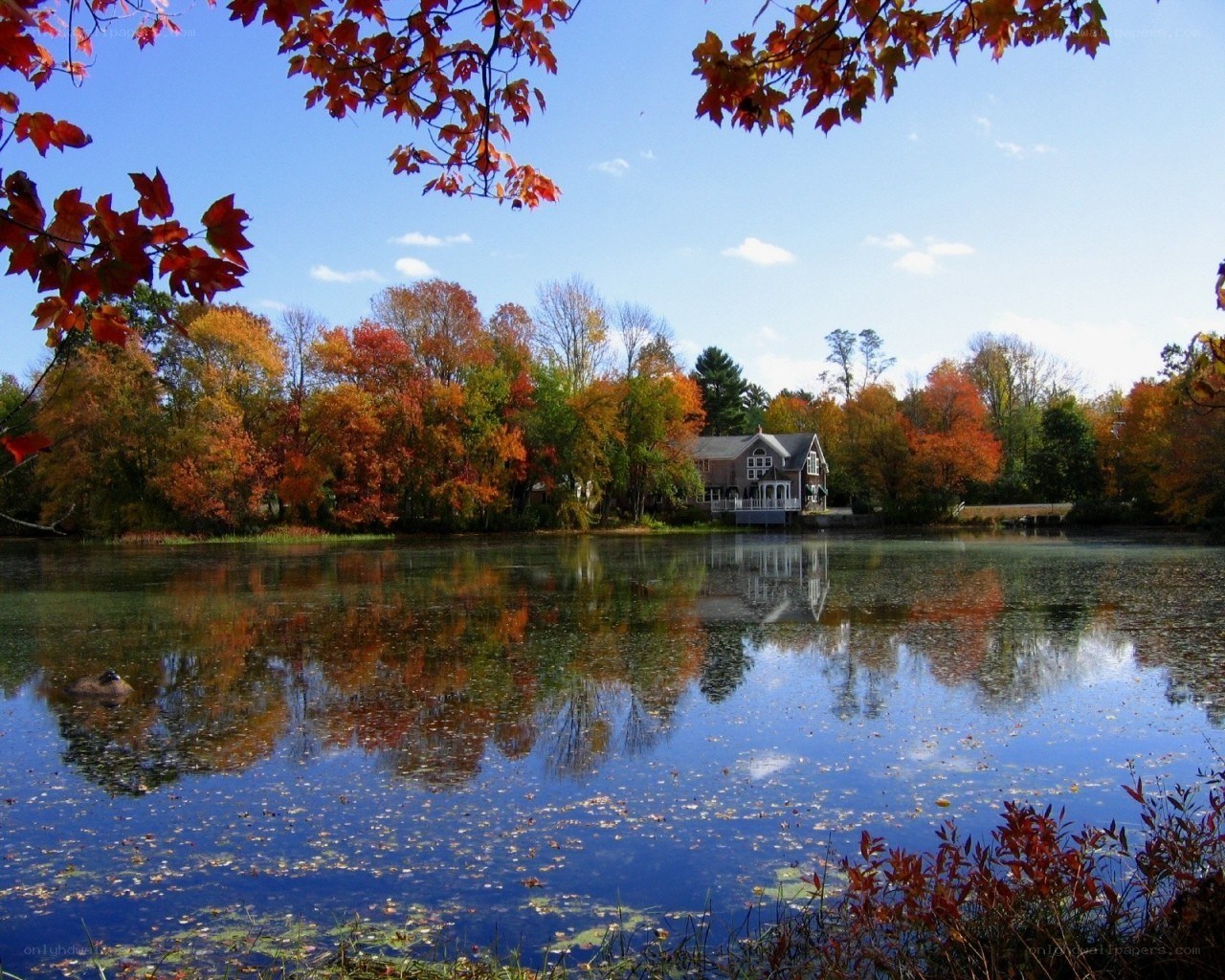 Autumn lake with house reflection