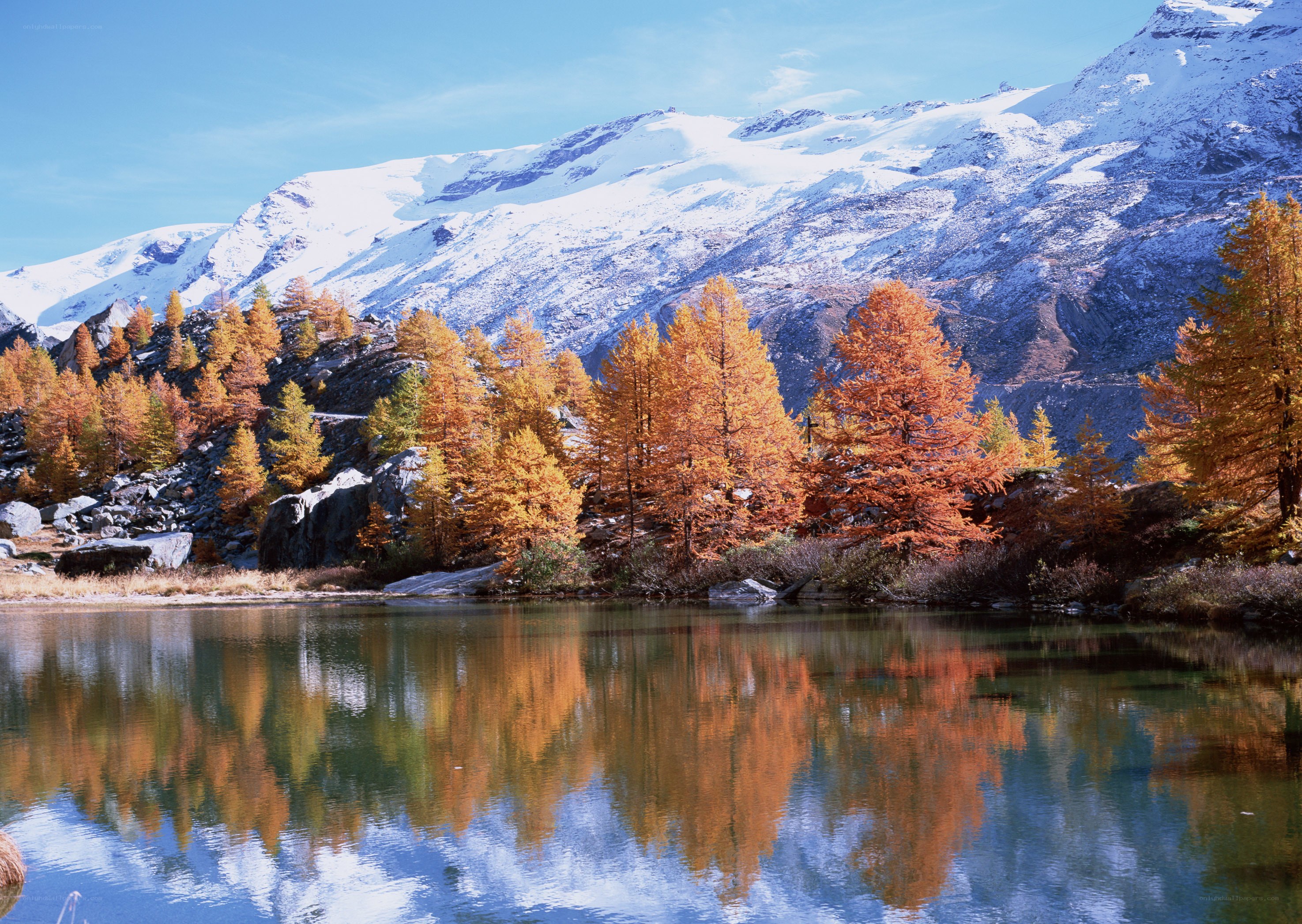 Autumn lake with mountain reflection