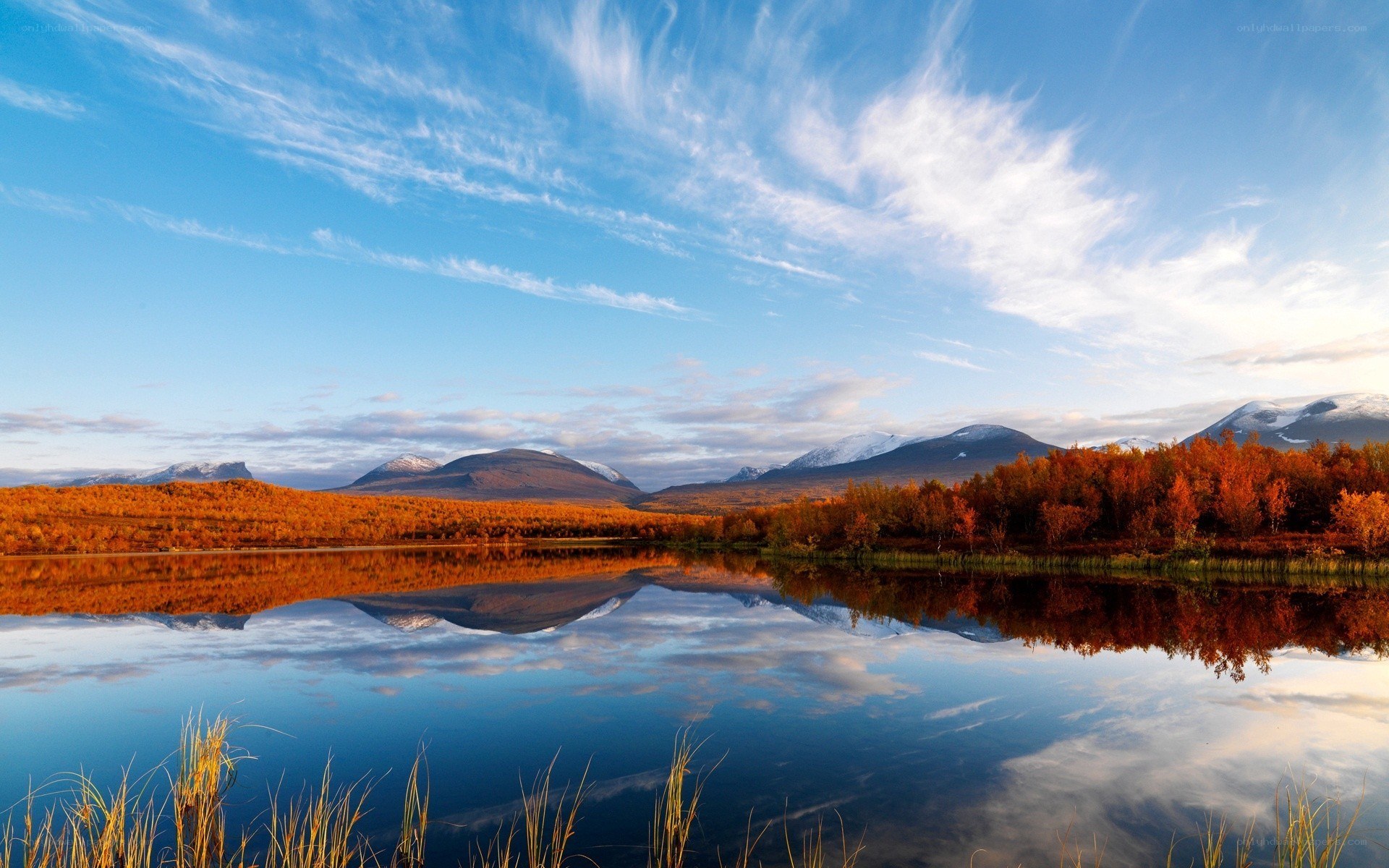 Autumn lake with mountain reflection