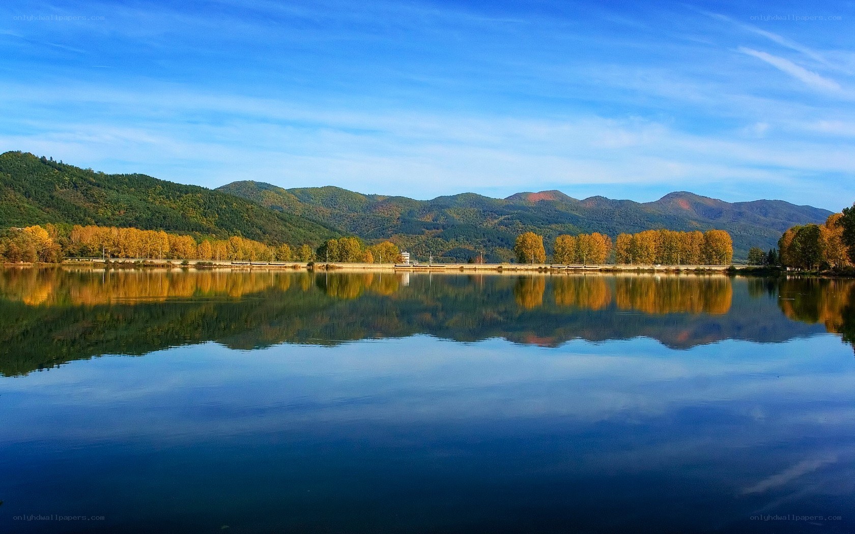 Autumn lake with mountain reflection