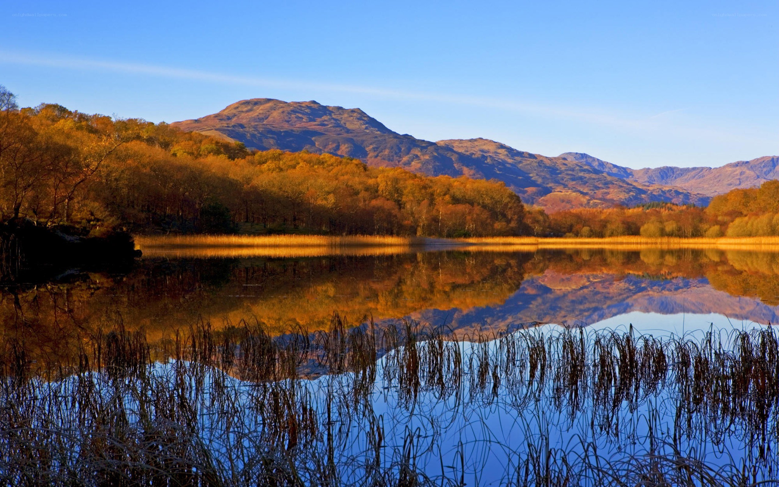 Autumn lake with mountain reflection