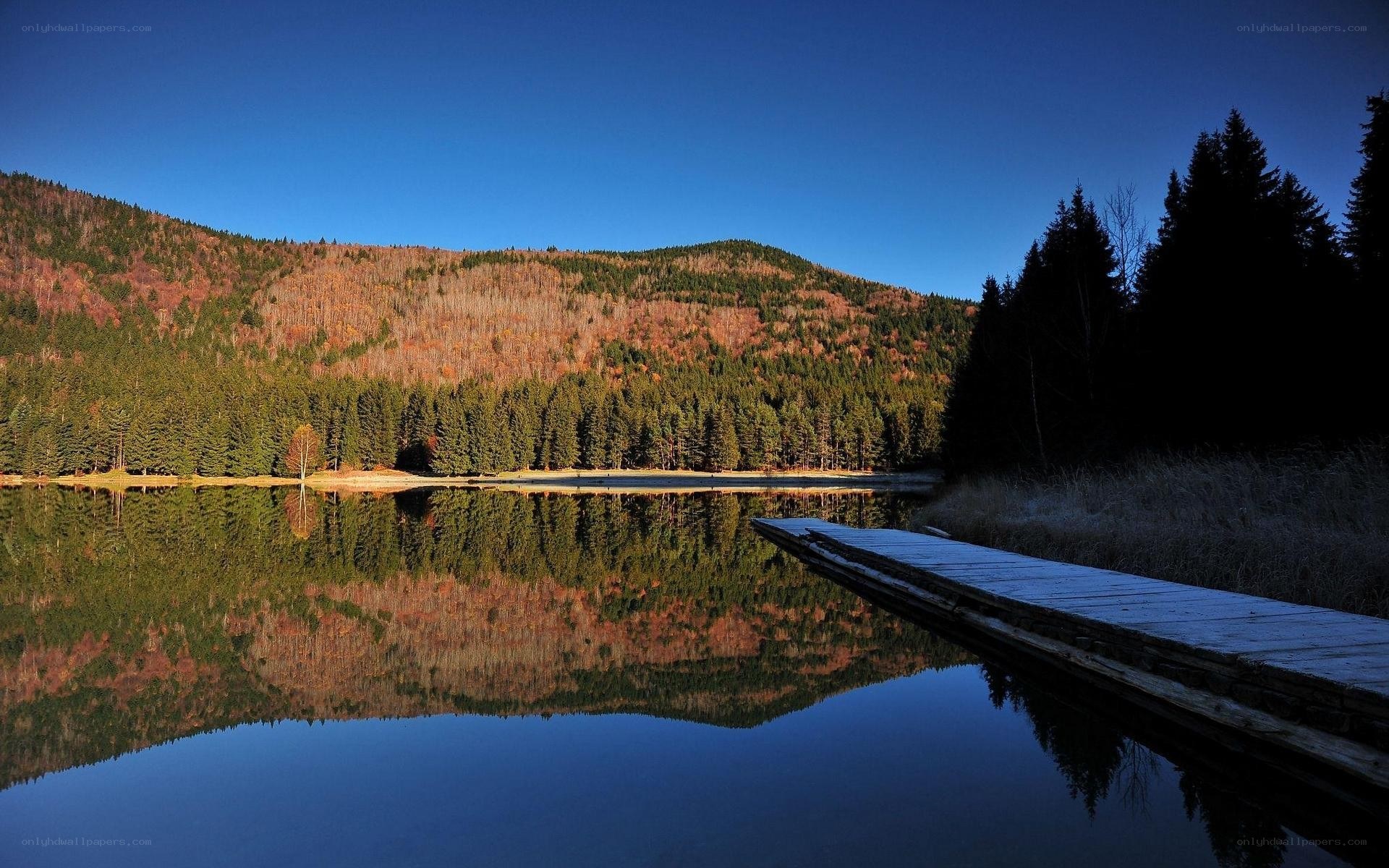 Autumn lake with mountain reflection