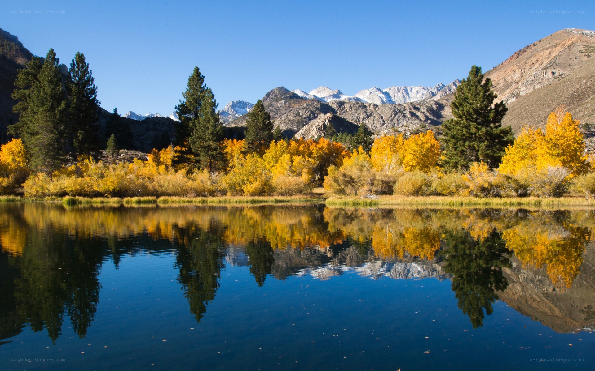 Autumn lake with mountain reflection
