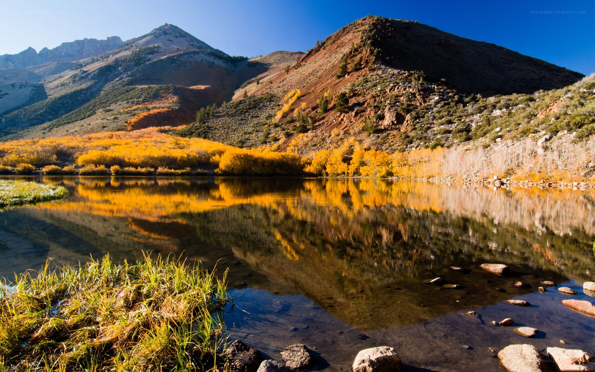 Autumn lake with mountain reflection