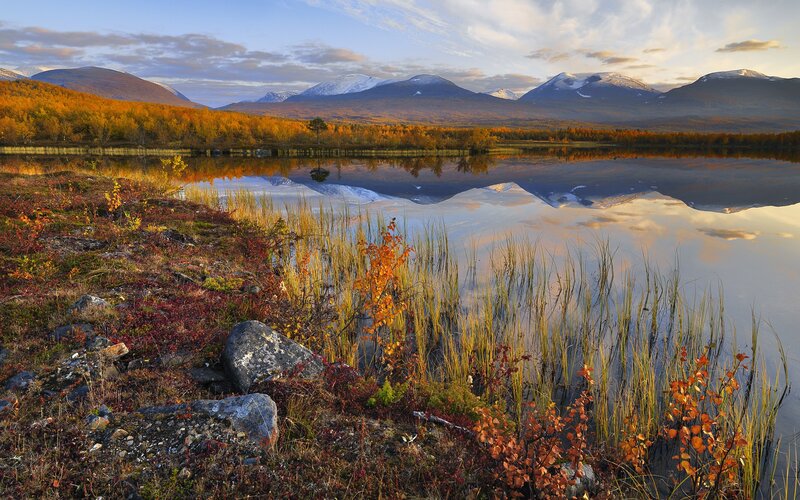 Autumn lake with mountain reflection