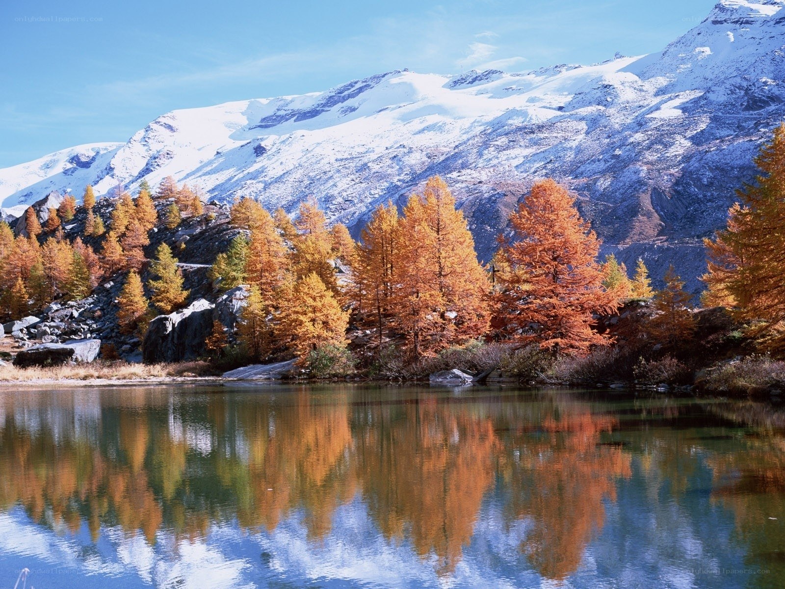 Autumn lake with snow-capped mountains